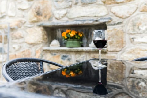 Patio with table and chairs and plant pots of flowers within the walls
