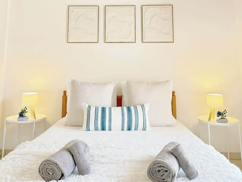 The master bedroom features a comfy double bed for a restful night’s sleep, extra pillows and blankets, ambient lighting, ample wardrobe space, air conditioning, and a private balcony with relaxing views of palm trees.