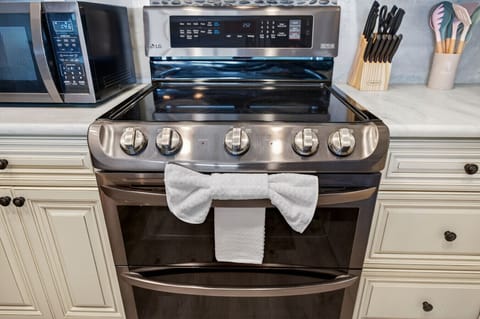 Modern range w/ clean lines & generous cooktop space, ideal for home-cooked meals.