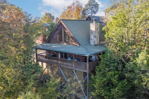 Escape to this cozy mountain cabin nestled among the trees with sweeping views of the Great Smoky Mountains. Unwind on the wraparound porch, breathe in the crisp mountain air, and experience the perfect blend of rustic charm and serene relaxation.