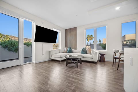 Floor-to-ceiling windows and patio access flood the room with natural light