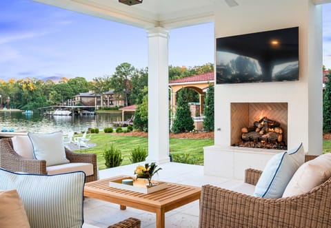 Covered porch with cozy seating and views of manicured grounds.