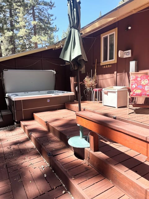 Deck with sliding door, deck, deck steps, and umbrella.