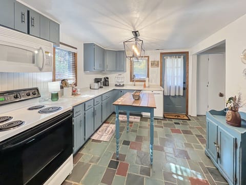 Electric stove and generous counter space for cooking.