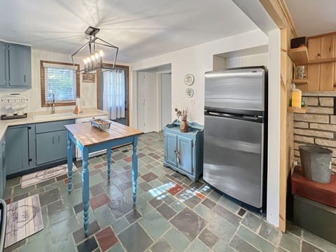 Full size refrigerator and freezer in the kitchen.