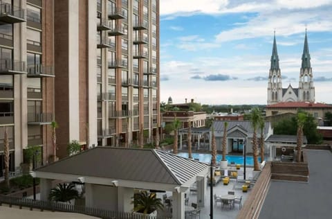 City view with cathedral towers above tree-lined streets