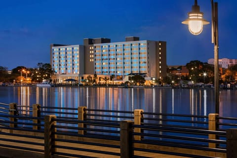 Riverside night view of Hotel Ballast reflecting on the water