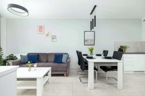 Bright and inviting living room with a comfortable sofa, modern coffee table, and flat-screen TV — perfect for relaxing after a long day.