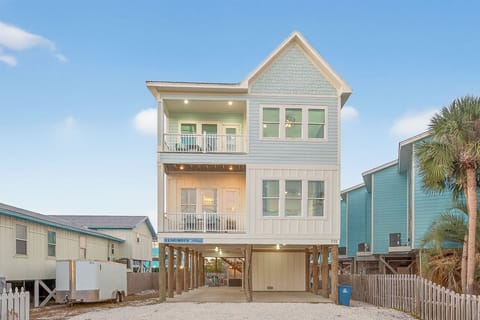 Beautiful coastal home exterior with spacious balconies and easy beach-house charm.