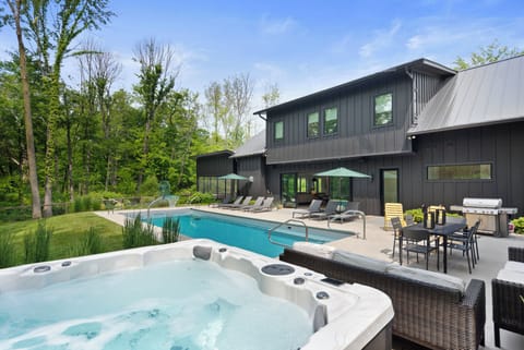 Resort-style backyard with pool, hot tub, and plenty of space to lounge