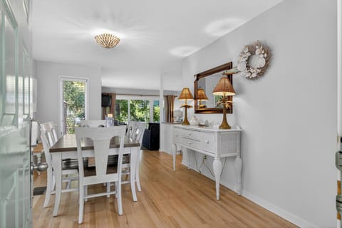 Gather around your elegant dining table where warm brass lighting creates the perfect ambiance for memorable meals together.