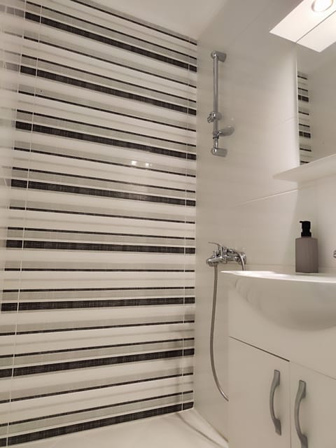 Shower, hair dryer, slippers, towels