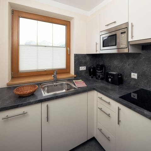 Deluxe Condo | Private kitchen | Highchair