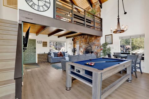 Open living room with pool table, dining area