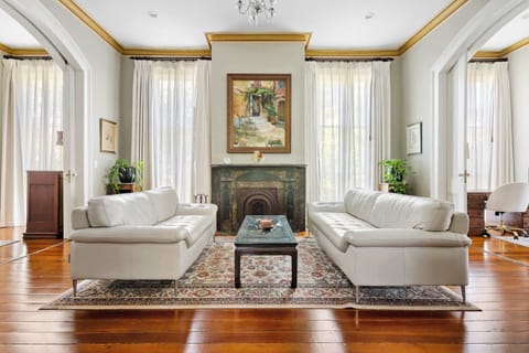 A stunning living room showcasing soaring ceilings, original wood floors, and historic character.