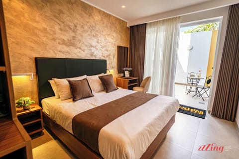 Deluxe Double Room, Patio | In-room safe, desk, laptop workspace, iron/ironing board