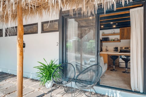 Loft 2 entrance — patio seating, thatched roof, Playa Grande