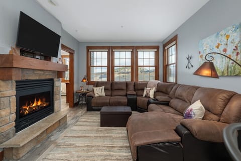 Sink into the plush sectional sofa at Kicking Horse Buckskin 3-205  by your crackling stone fireplace, where warm flames and mountain views create the perfect retreat.
