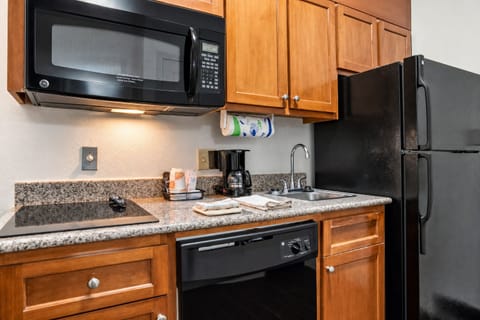 Prepare quick meals with microwave, fridge, and granite counters.