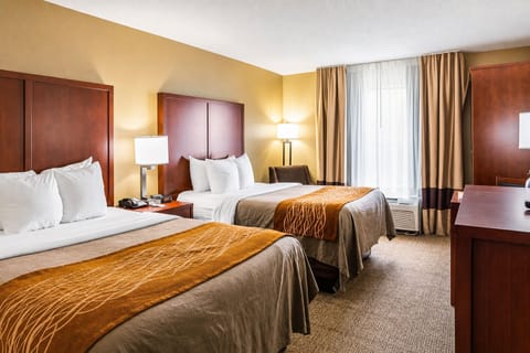 Sink into crisp linens as sunlight fills the cozy room.