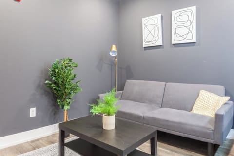 Bask in the warmth of natural light as our living room's cozy sofa couch becomes a haven of comfort and relaxation.