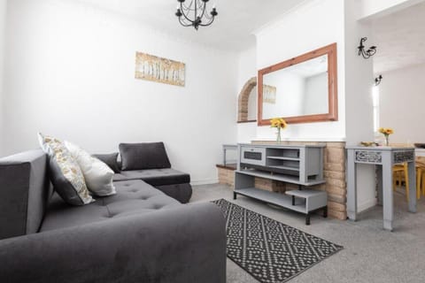 Cosy living space with L-shaped sofa, furnishings and sideboard