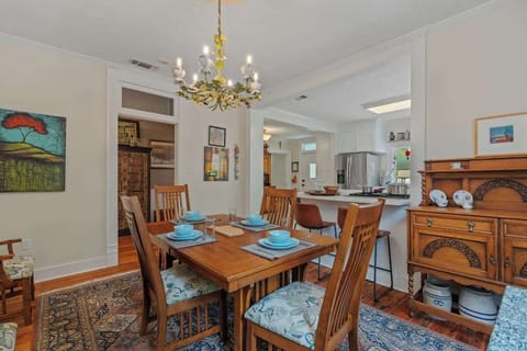 Stylish Dining Room with Buffet Storage & Kitchen View.  This beautifully styled dining room features elegant buffet cabinets, perfect for serving and storage, all set beneath curated décor that brings warmth and sophistication to the space.