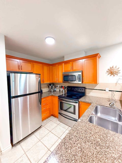 Unit A. So much counterspace! Fridge, stove, microwave and dishwasher.