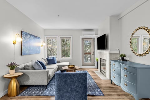 Make yourself at home in the living area accented with soft blue hues for a refined yet cozy vibe