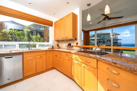  Start your mornings in a bright, open kitchen surrounded by sunlight, tropical views, and modern stainless steel charm    KBV-28G2