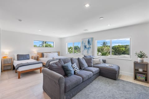 Your bright Delray Beach studio features a king bed, twin bed, sectional lounge, and wide windows that make the open-concept space feel airy, private, and comfortable.