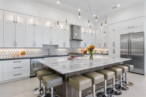 Massive porcelain island – seats eight for cocktails, breakfast, or casual gatherings.