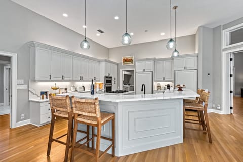 Sleek cabinetry and high-end appliances create a bright, polished space for cooking and entertaining.