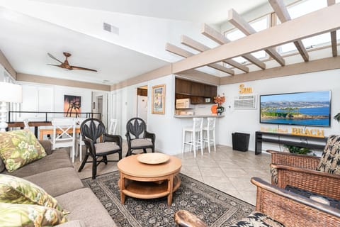 Stairs lead up to the main level, where you'll find a sofa, additional seating, cable TV, and the kitchen just beyond
                