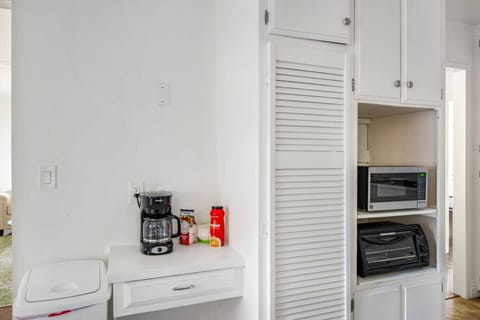 Convenient coffee and breakfast station equipped with a coffee maker, toaster, and microwave.