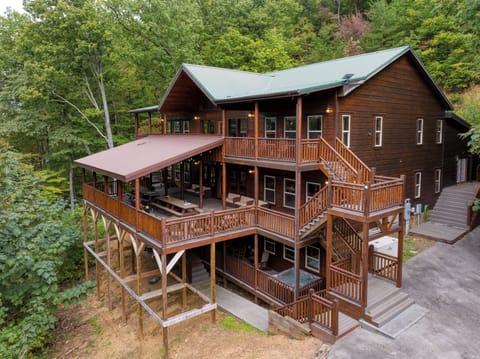 Your ultimate mountain escape awaits. This massive, multi-level cabin retreat offers endless decks, stunning views, and space for everyone to gather and relax.