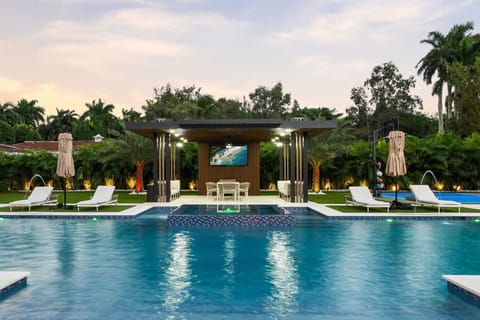 Resort-style pool and spa at sunset