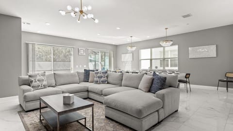 Living Room: Bright, spacious living area perfect for movie nights and family gatherings featuring plush seating, a large Smart TV, and natural light.