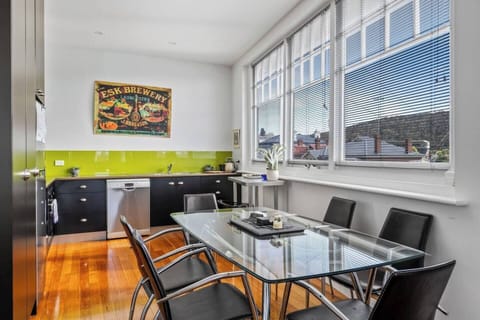 An open plan dining area and kitchen offers ample space to cook up a storm and enjoy a meal overlooking the surrounding landscape.