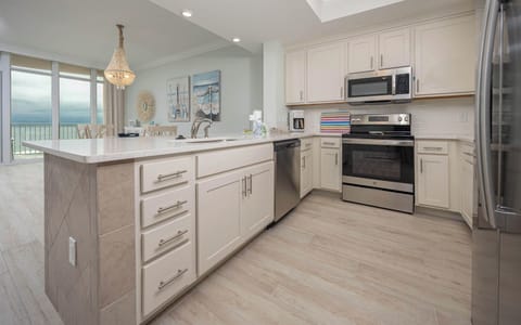 Prepare meals in this kitchen with elegant cabinetry, stainless appliances, and spacious countertops
