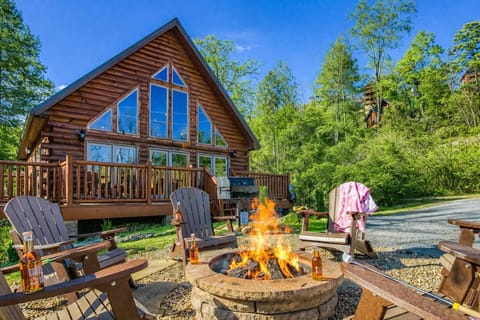 Gather around the cozy fire pit with Adirondack chairs, nestled in front of the cabin—perfect for evening conversations, laughter, and Smoky Mountain memories under the stars.