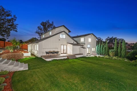 Spacious backyard with lush lawn and evening ambiance