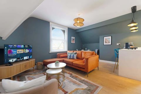 A spacious living room featuring a Smart TV and ample seating, creating the perfect place to relax, unwind, and enjoy entertainment throughout your stay.