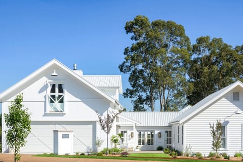 Modern farmhouse retreat with heated pool, covered outdoor lounge and dining overlooking landscaped lawns, parkland and golf course. Fully enclosed yard perfect for pets. Designed for wedding accommodation and elevated family/group holidays.