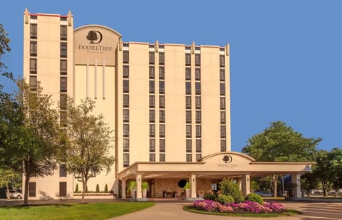 Daytime view of DoubleTree exterior with garden and trees