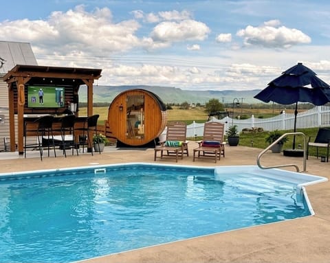 Escape to your private backyard oasis! 
The ultimate patio experience awaits: soak in the refreshing pool, detox in the barrel sauna, or grill on the Blackstone. Catch the game at the outdoor bar while enjoying stunning scenic views.