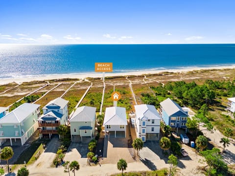 Coastal vacation homes in a beachfront community with direct beach access paths and stunning ocean views.