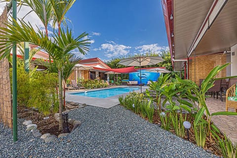 Beautiful tropical garden leading to a serene pool retreat.