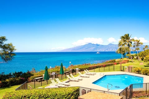  Soak up the sun beside a sparkling oceanfront pool, with stunning views of Molokai across the channel and swaying palms framing the perfect tropical escape. NAP-B43