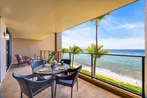 Unwind on a roomy oceanfront balcony with comfortable seating and panoramic views